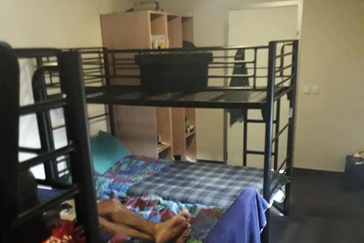 A small room with bunk beds.