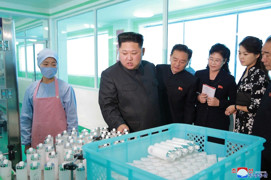North Korean leader Kim Jong-un and wife Ri Sol-ju examine cosmetics at a factory.