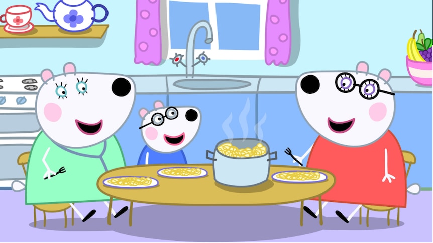 A child cartoon polar bear and two adult, female cartoon polar bears sit at a kitchen table and eat spaghetti from a pot.