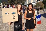 Two French women at a vigil at Federation Square