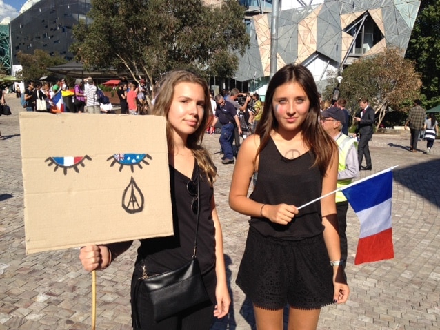 Two French women at a vigil at Federation Square