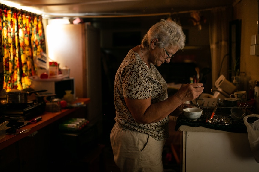 Cheryl works on the kitchen bench