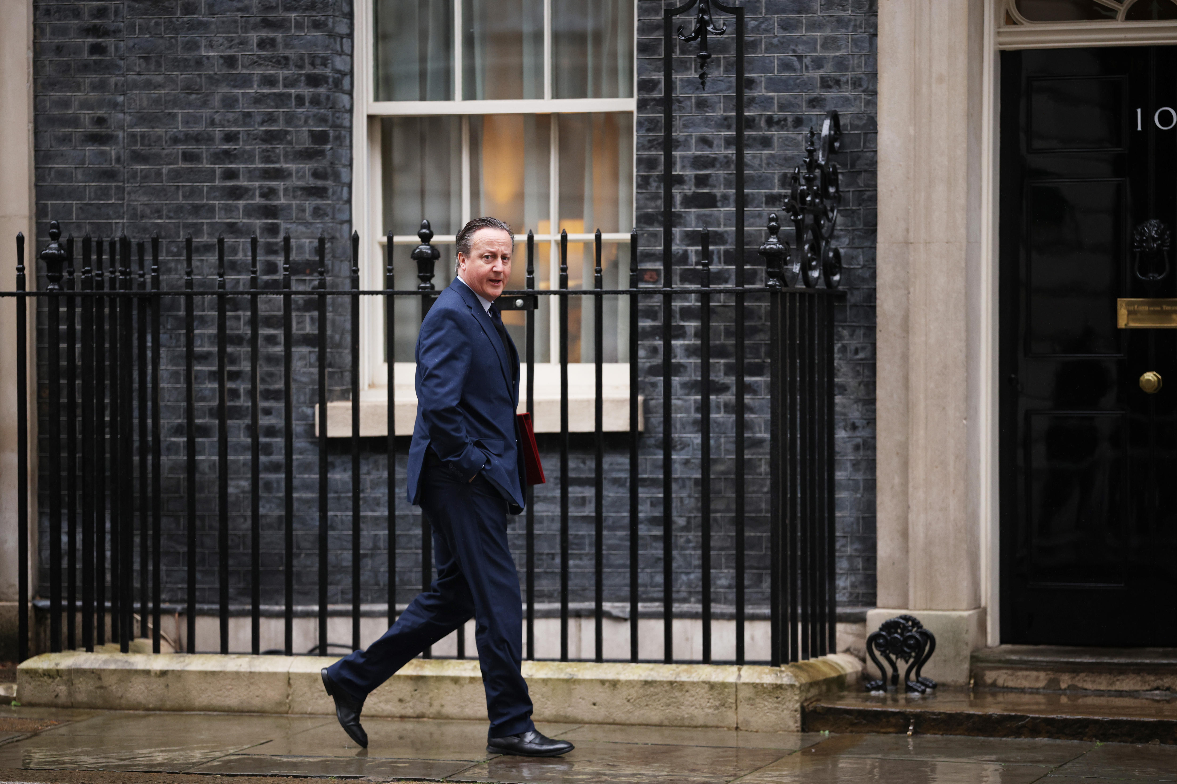 David Cameron walks outside of 10 Downing Street. 