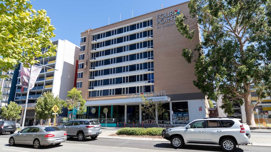 The exterior of the Four Points Sheraton in Perth with cars on the road below.