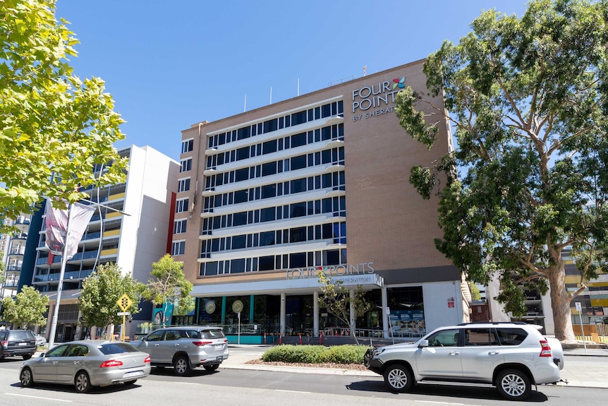 The exterior of the Four Points Sheraton in Perth with cars on the road below.