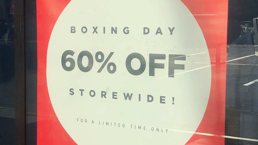 A red sign with a white circle inside saying 60% OFF storewide