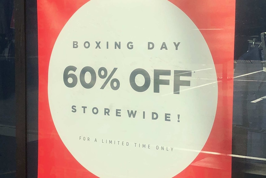 A red sign with a white circle inside saying 60% OFF storewide