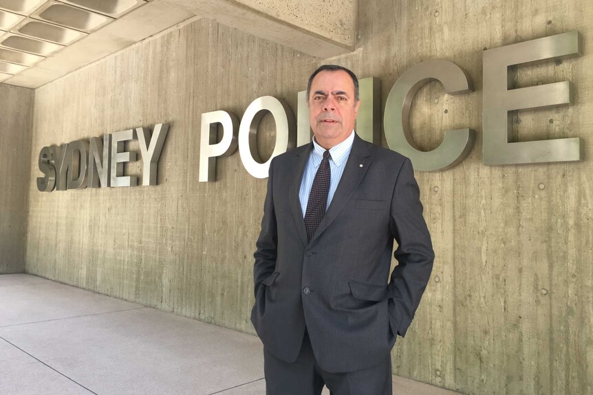 Deputy Commissioner Nick Kaldas standing in front of a large Sydney Police sign.