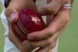 Screengrab of James Anderson holding the ball