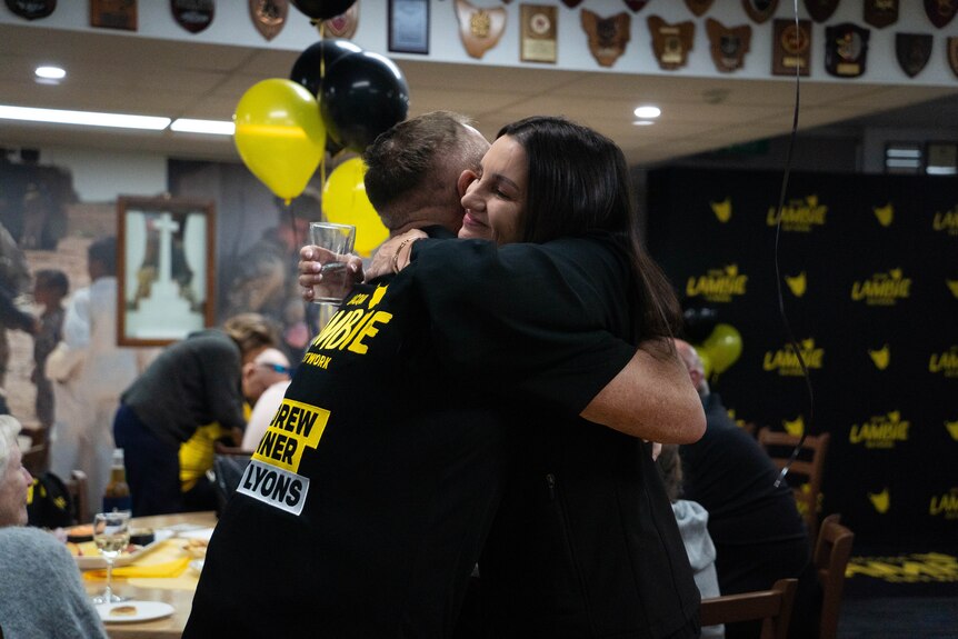 Andrew Jenner and Jacqui Lambie hugging.