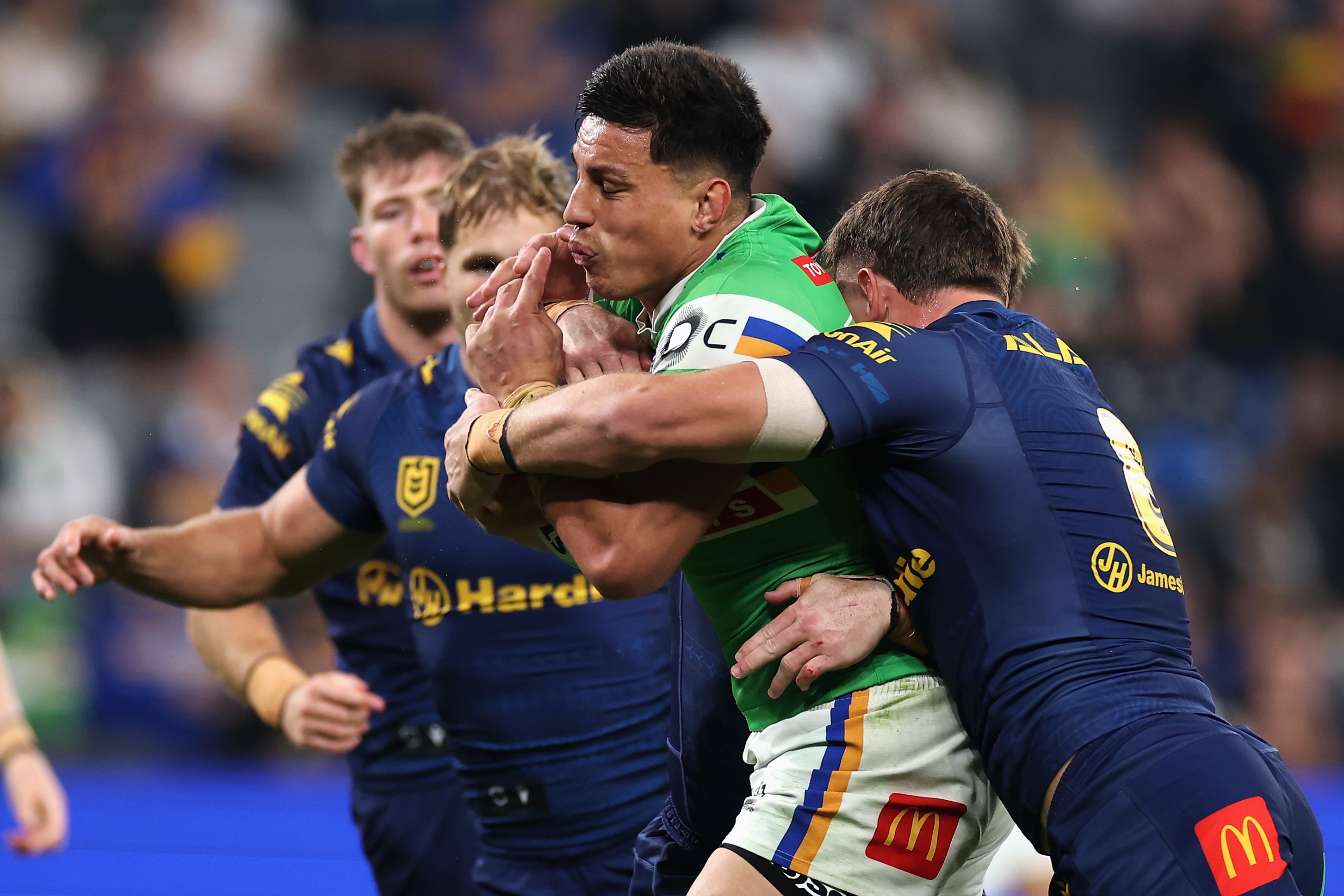 A man runs the ball during an NRL match