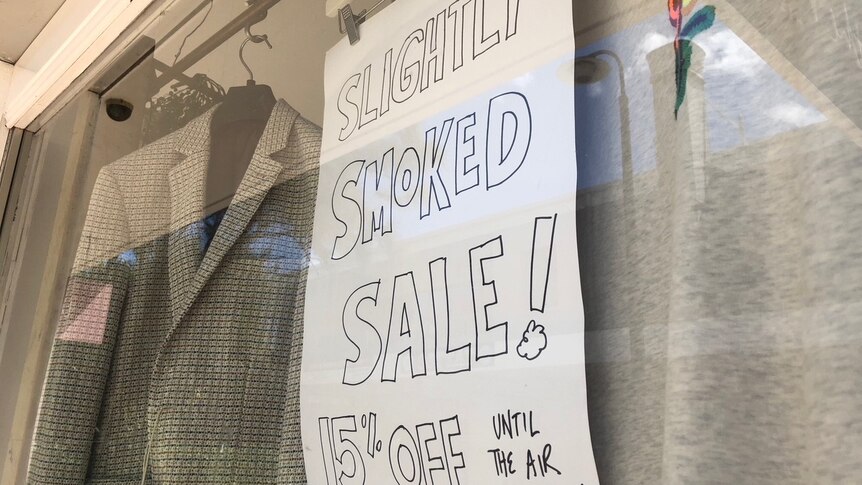 "Slightly smoked sale sign" in the window of a Peregian business.