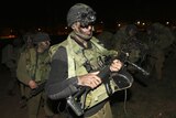 Israeli soldiers advance near the border with central Gaza.