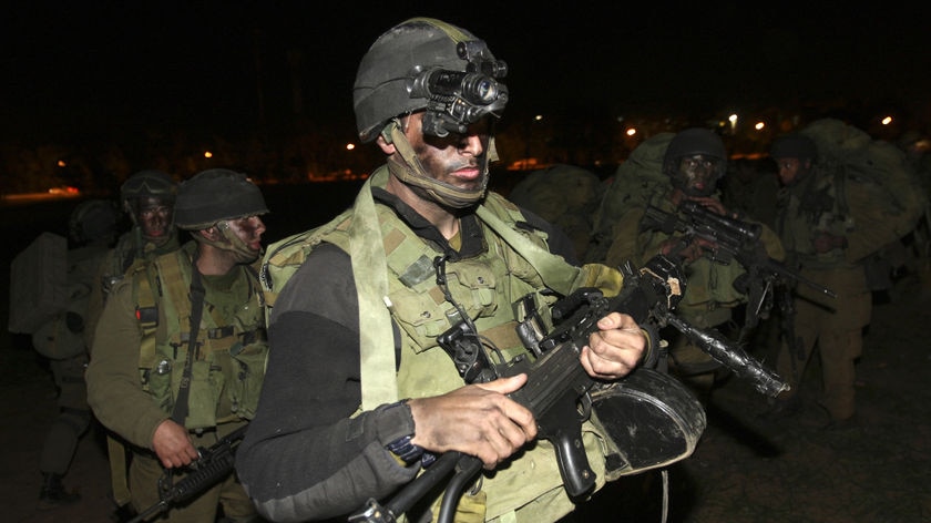 Israeli soldiers advance near the border with central Gaza.