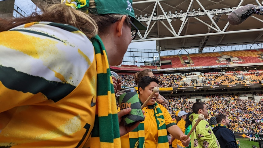 Matildas Active Support fans bang a drum in the stands during a game at Suncorp Stadium. 