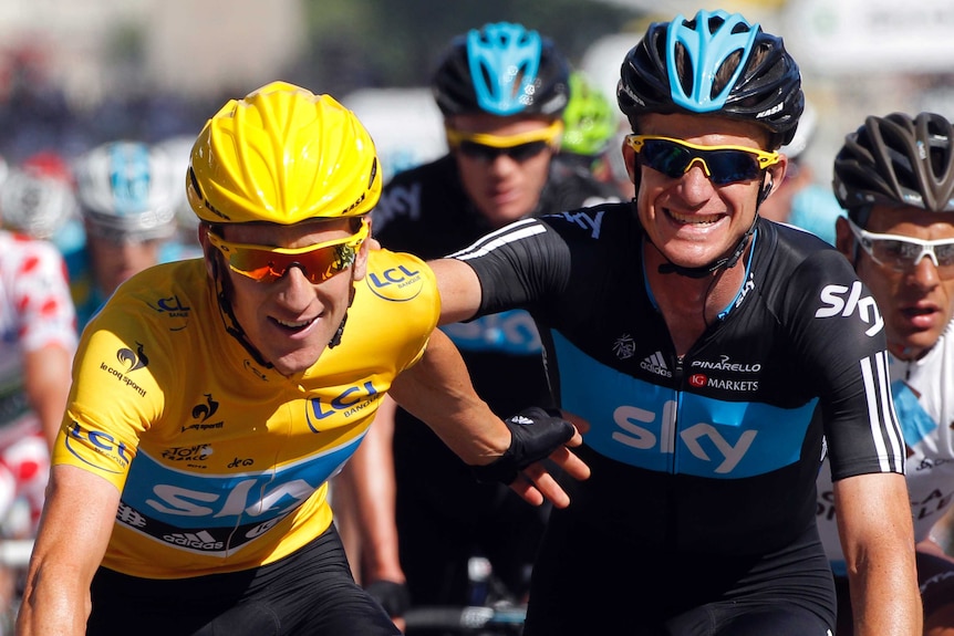 Team Sky's Bradley Wiggins (L) is congratulated by Michael Rogers at the 2012 Tour de France.