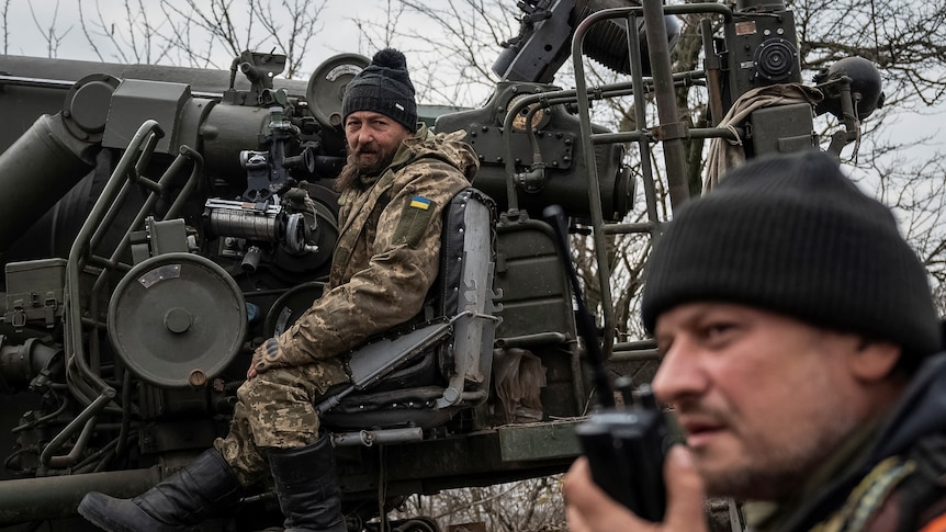 Ukrainian soldiers sitting inside a vehicle.