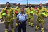 Station officer Gina Kikos, flanked by four male fire fighters