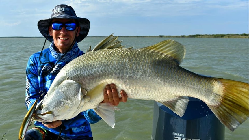 A saltwater barra and a happy fisherman
