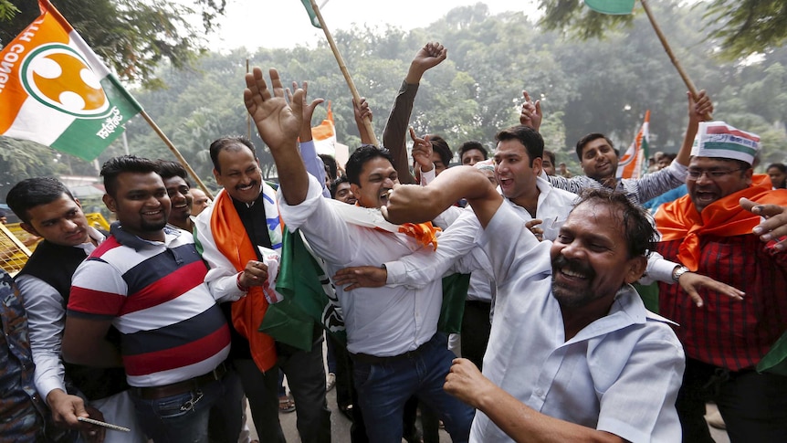 Supporters of Narenda Modi's opposition celebrate.