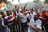 Supporters of Narenda Modi's opposition celebrate.