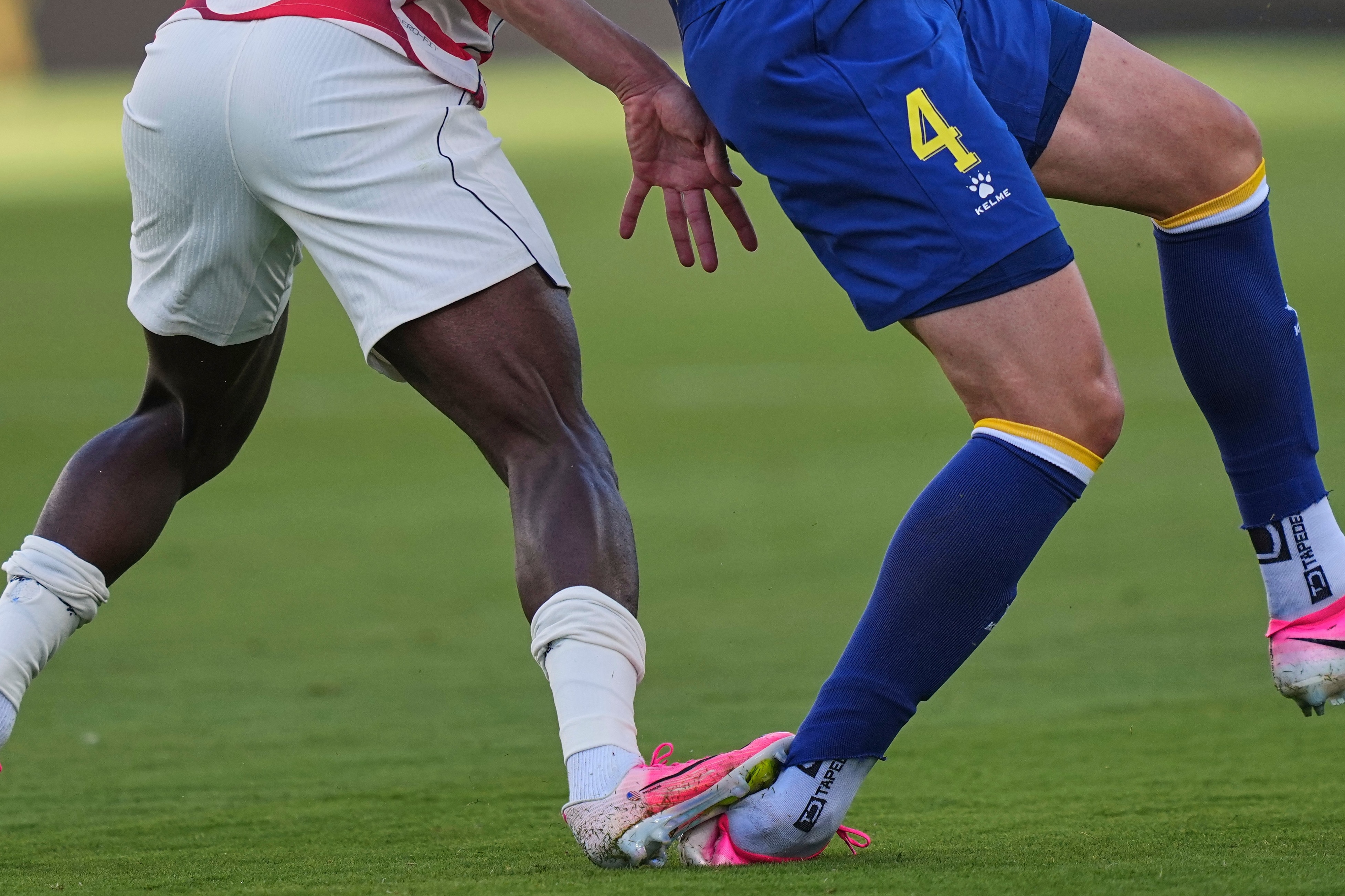 A close up of Folarin Balogun's foot on Tarik Muharemovic's ankle