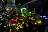 Lasers shining on a clock in a lab.