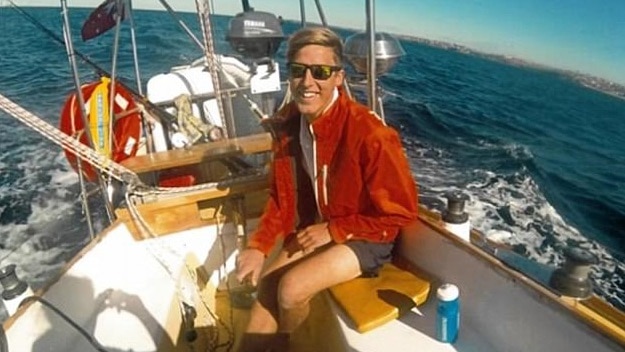 Nicholas Banfield at the tiller of a yacht