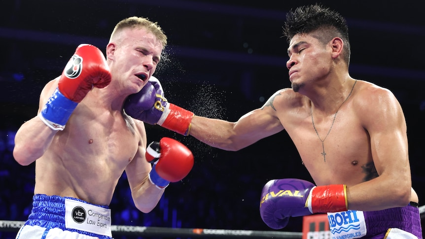 Liam Wilson is punched in the head by Emanuel Navarrete