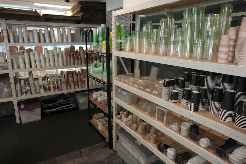 BioPak takeaway cups and containers sitting on shelves in a warehouse