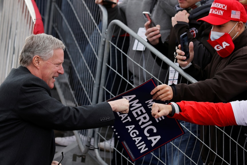 White House Chief of Staff Mark Meadows greets supporters of Donald Trump.