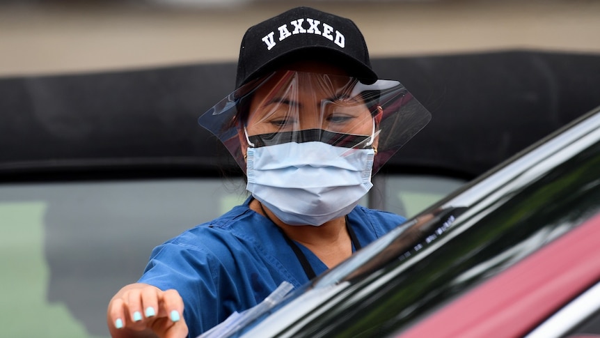 A woman in a vaxxed hat collecting a sample.