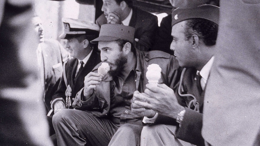 Black and white photo of Fidel Castro eating an ice cream cone.