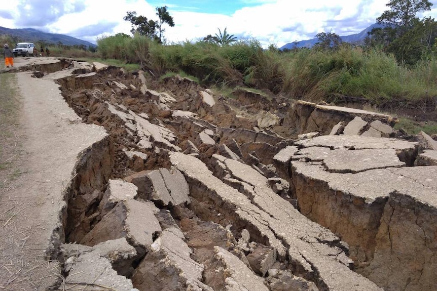 Large parts of a road are cracked.