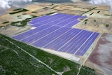 Aerial view of a large solar farm on rural land