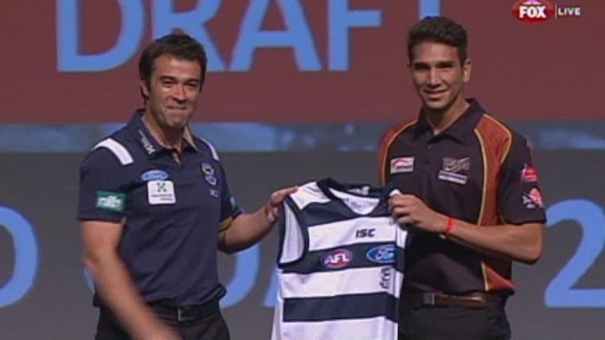 Nakia Cockatoo being presented with a Geelong Cats jumper
