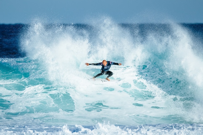 Kelly Slater rides a big wave tube.