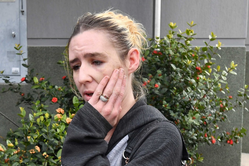 A resident of the mobile home park at Stapylton speaks to the media outside the Logan Central Police Station.