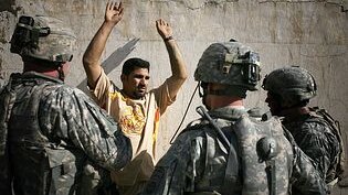 US soldiers question a man Baghdad in July 2007