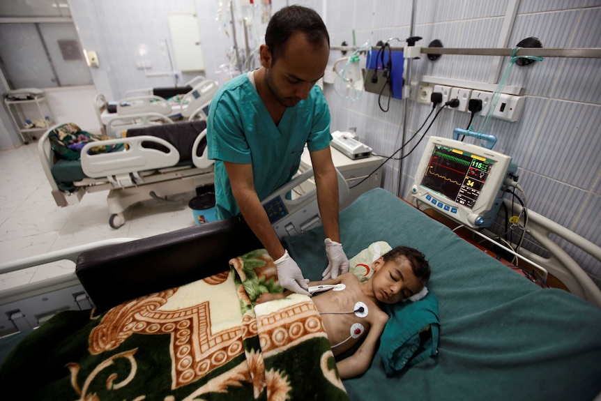 A nurse checks a boy at a hospital intensive care unit in Sanaa, Yemen September 27, 2016.