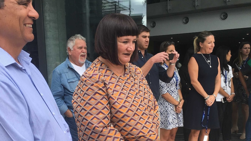 Raelene Castle watches an Indigenous smoking ceremony.