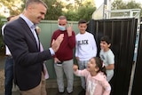 Syrian refugee Rateb Alkhalil and his family meet with Peter Malinauskas.
