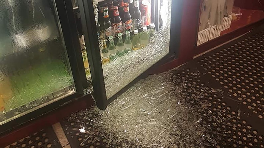 A photo of smashed glass in a beer fridge following a commercial break-in.