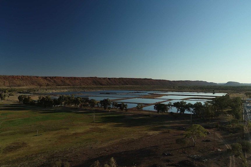 An aerial drone shot of the Alice Springs Sewage Ponds at dusk.