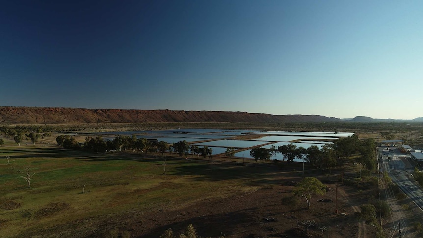 An aerial drone shot of the Alice Springs Sewage Ponds at dusk.