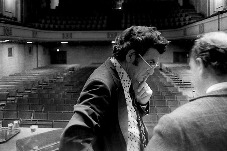 Bob Hawke inside an empty hall.