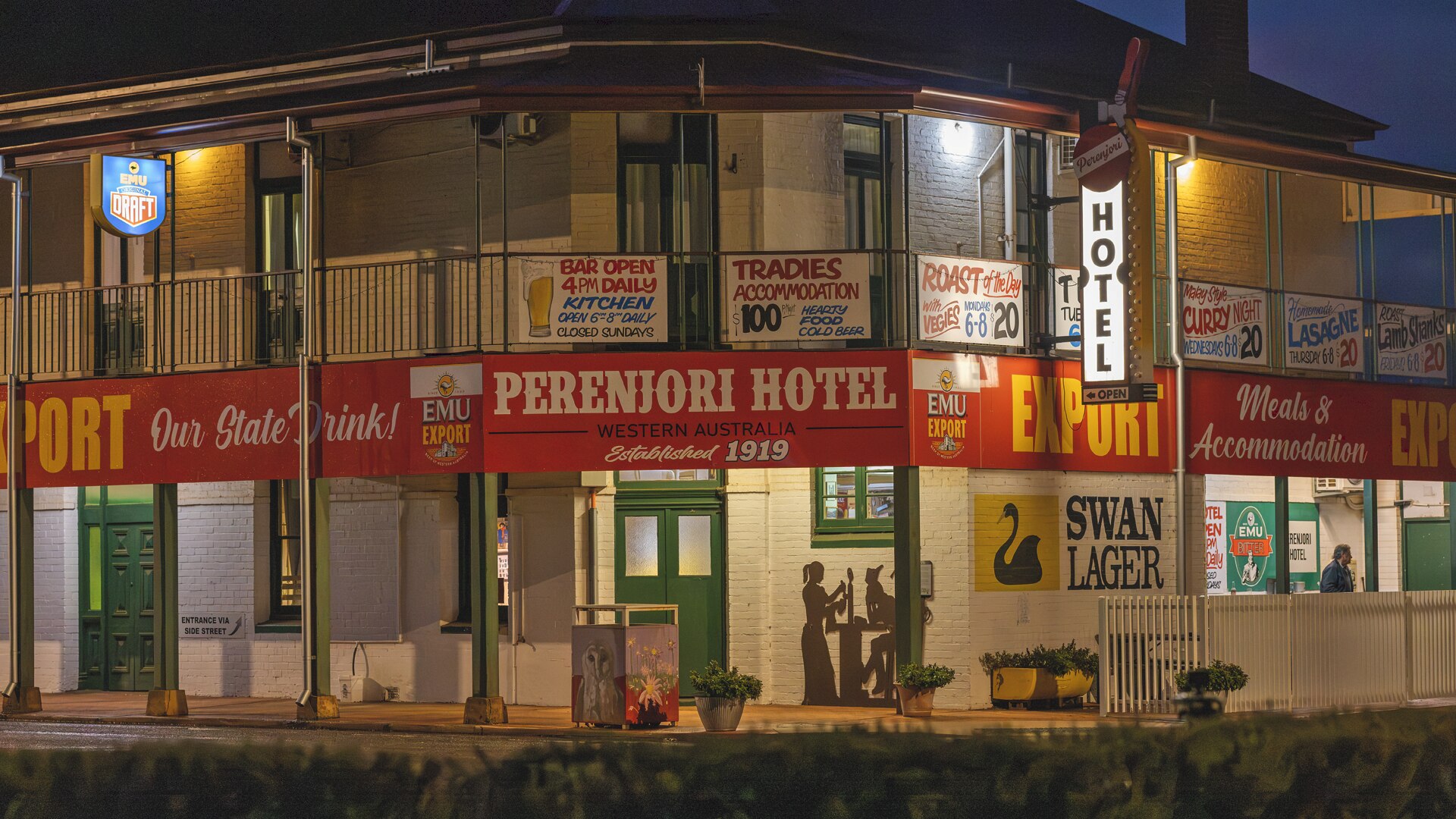 A two story building with a sign saying 'Perenjori Hotel' and beer adverts