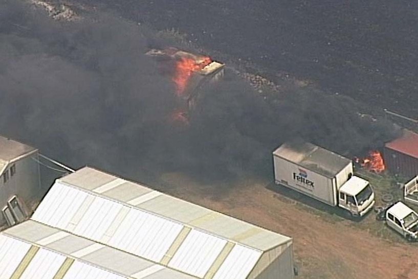 Black smoke coming from some buildings on fire near Little River.