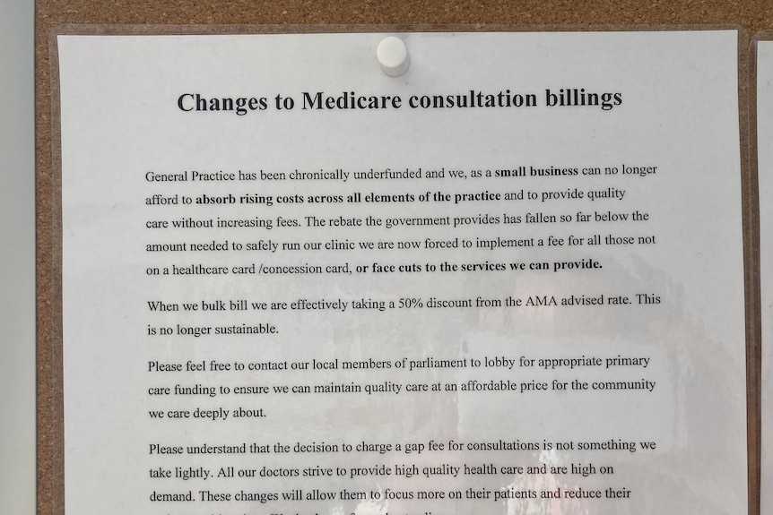 A sign is posted on a notice board telling patients that the clinic is underfunded and fees will increase.