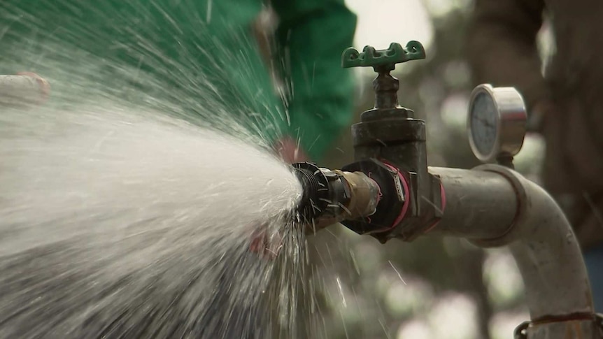 Water sprays from a bore tap.